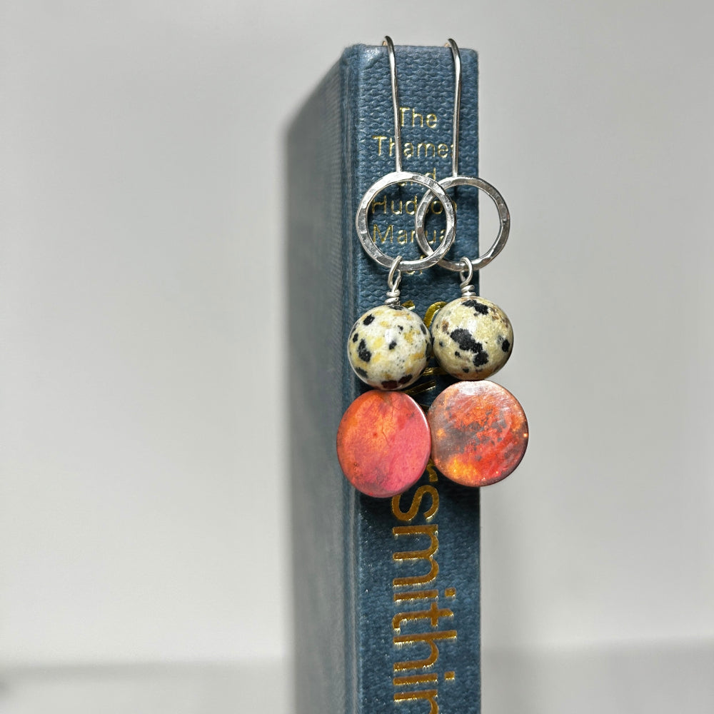 Silver hook style earrings with an open silver circle at the top, a natural Jasper Dalmation stone, then a coloured copper disk below, by zoe ruth designs