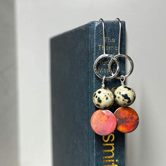 Silver hook style earrings with an open silver circle at the top, a natural Jasper Dalmation stone, then a coloured copper disk below, by zoe ruth designs