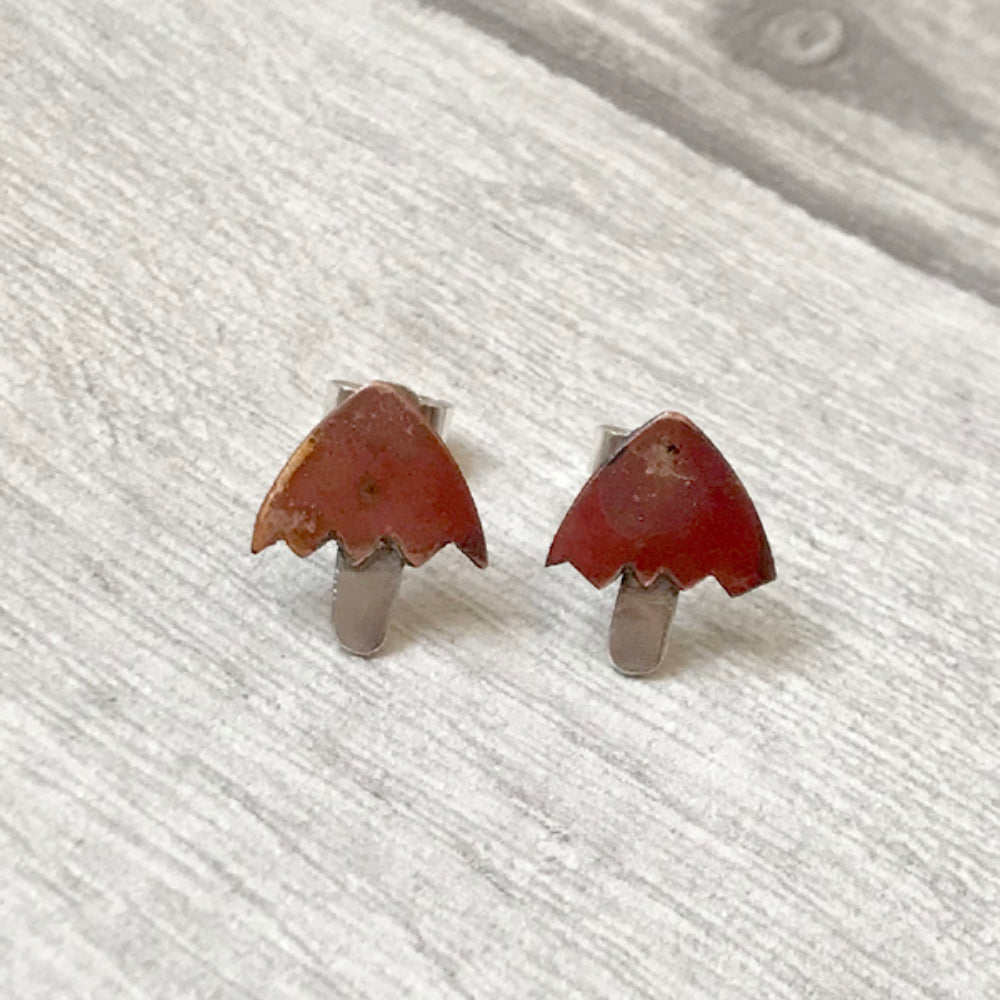 A pair of mushroom shaped earrings with copper tops and silver stalks by zoe ruth designs