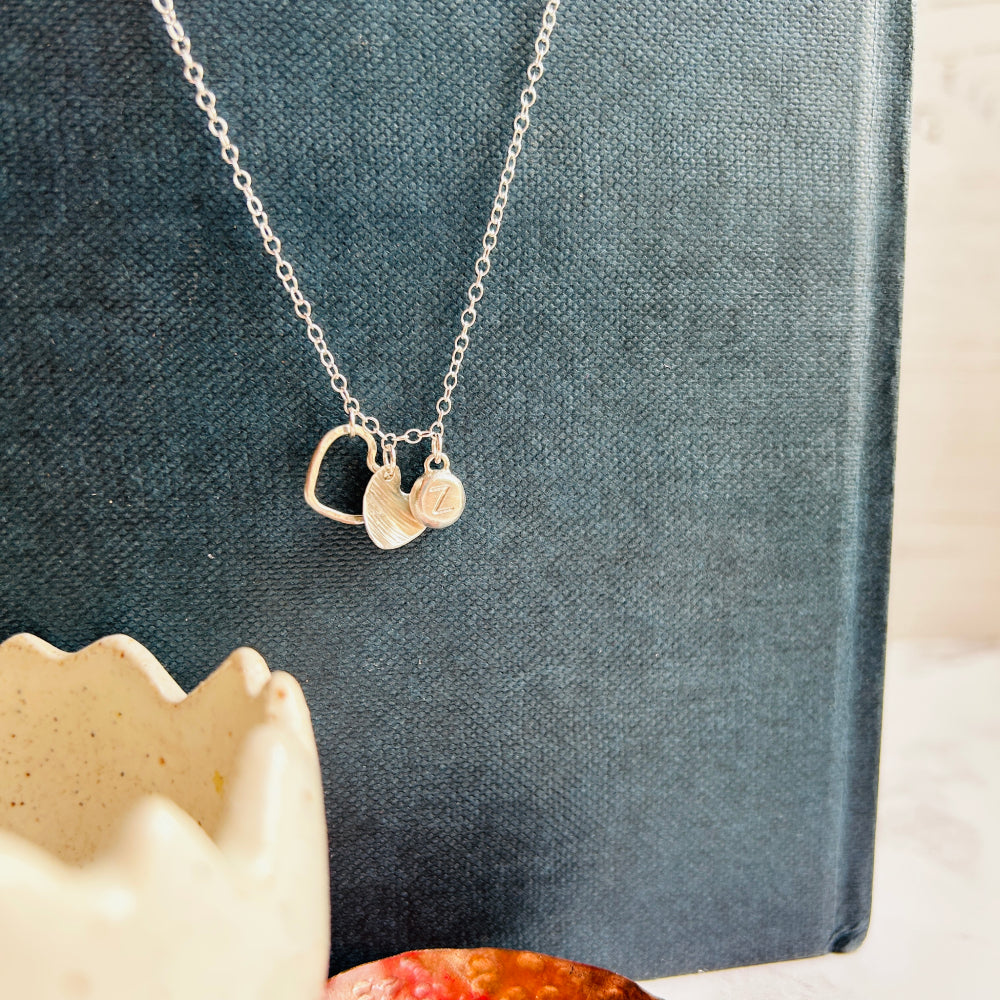 hanging necklace with silver heart outline, solid heart, personalised silver charm by zoe ruth designs