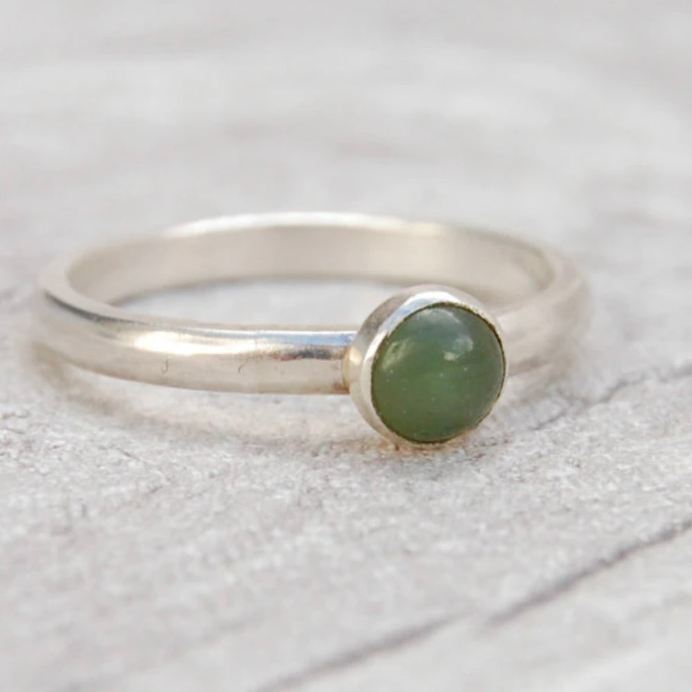 A single stone set silver ring, showing a moss green Jade stone, by zoe ruth designs