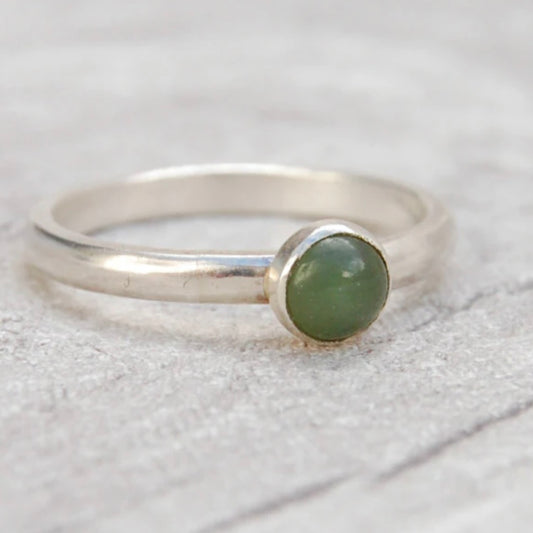 A single stone set silver ring, showing a moss green Jade stone, by zoe ruth designs