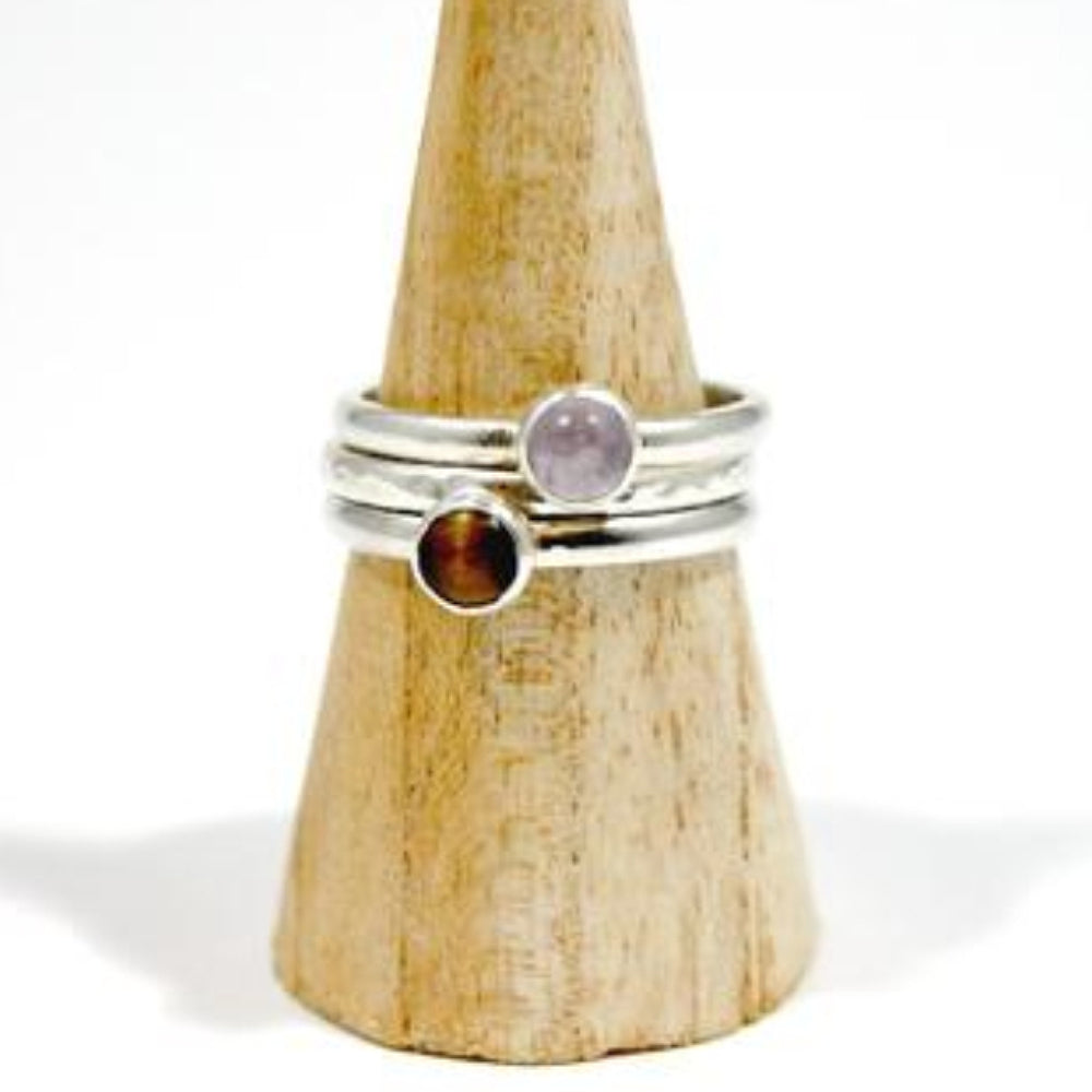 Showing three silver rings, one with a textured surface, one with a lavender amethyst stone, one with a tigers eye stone, by zoe ruth designs