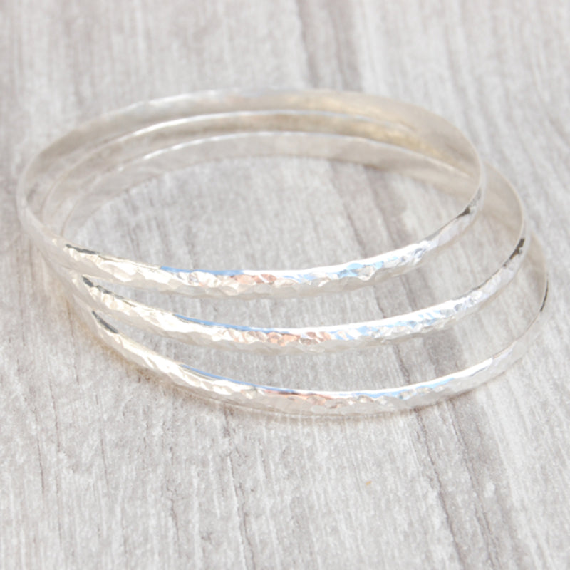 Three classic hammered D profile bangles shown together, by zoe ruth designs