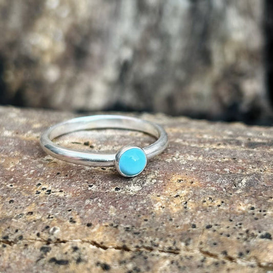 Showing a single pale turquoise stone set on a silver ring bnad, by zoe ruth designs