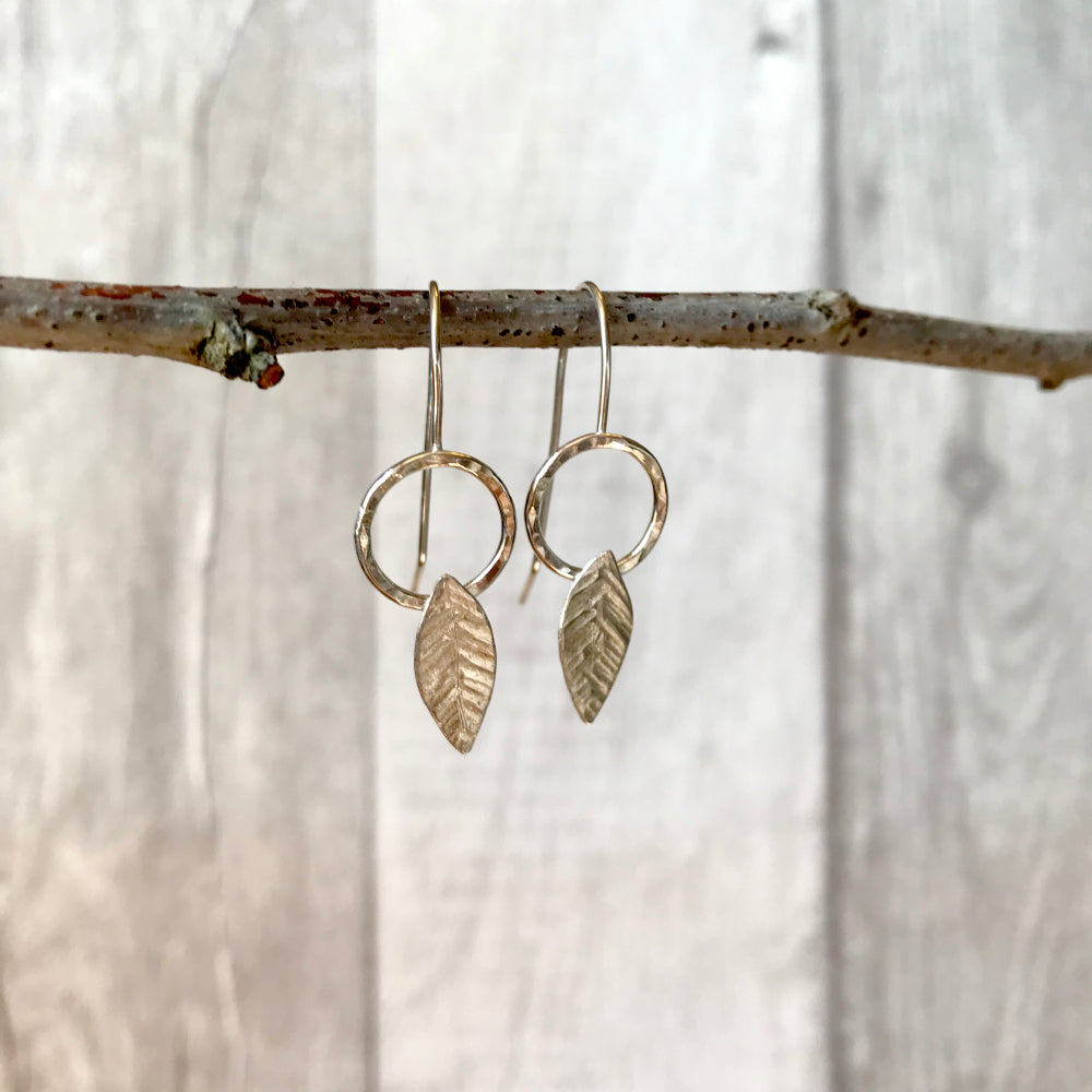Silver hook earrings, open circle with solid silver leaf shape, scribed leaf detail, by zoe ruth designs.
