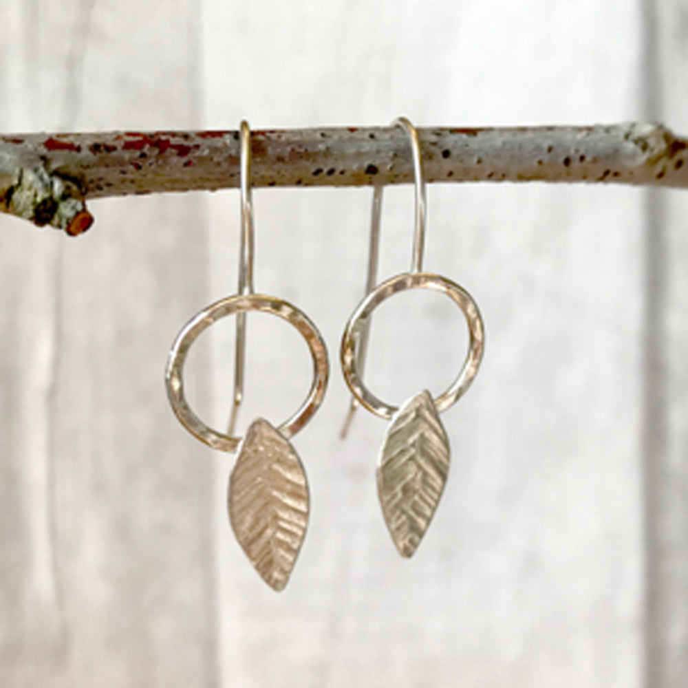 Silver hook earrings, open circle with solid silver leaf shape, scribed leaf detail, by zoe ruth designs.
