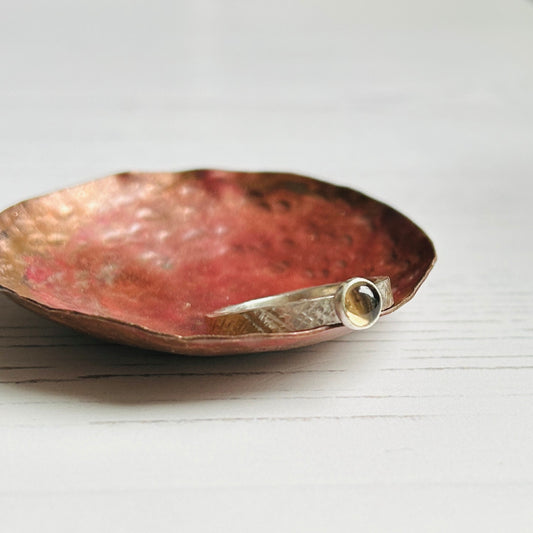 smokey quartz stone bezel set on a hammer textured silver ring band
