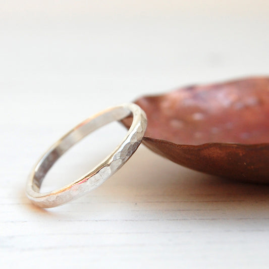 Showing a handmade silver stacking ring with a soft dimple texture by zoe ruth designs