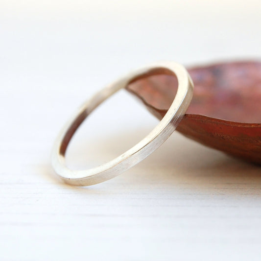 A smooth surfaced flat profile silver ring, by zoe ruth designs
