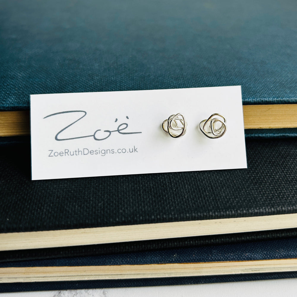 Handmade sterling silver stud earrings displayed on their logo card packaging of Zoe Ruth Designs