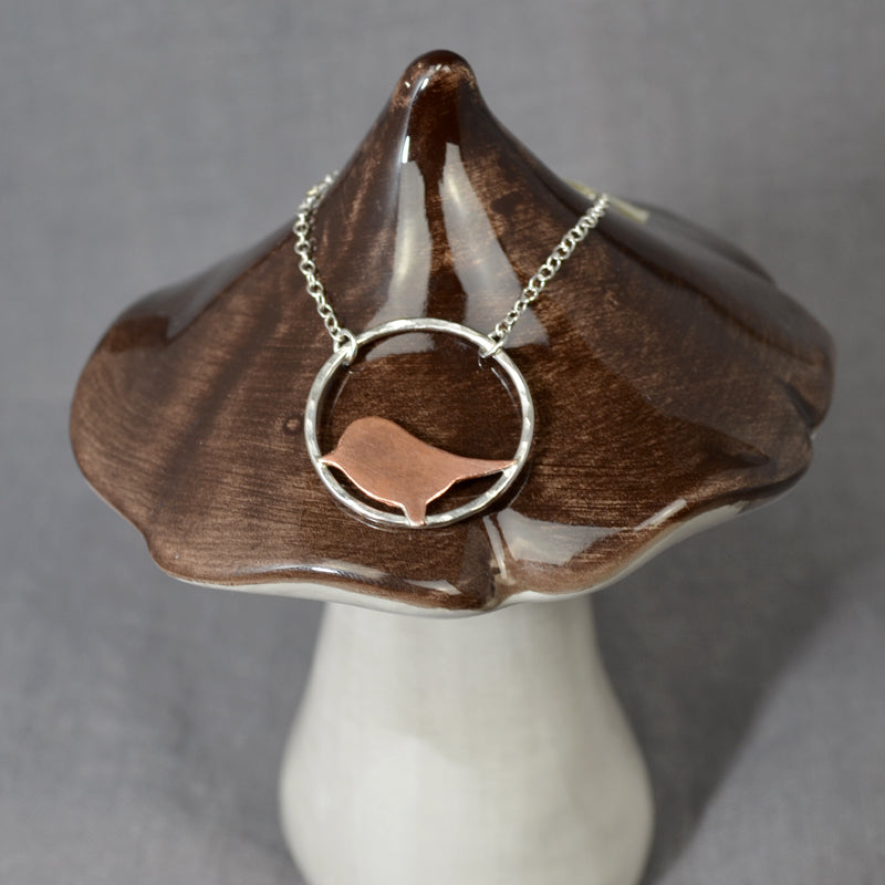 Copper bird on silver circle necklace