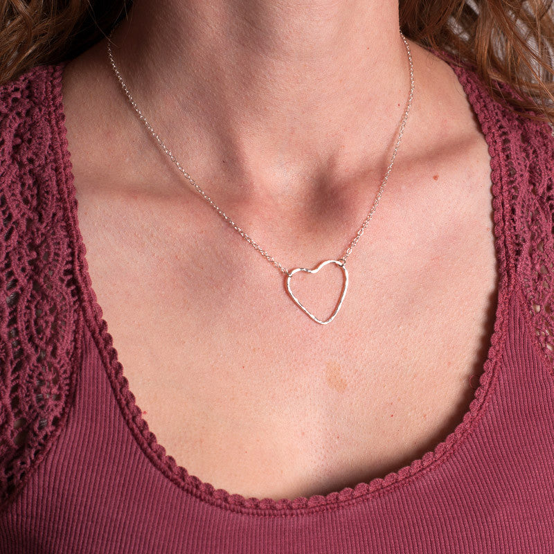 A sterling silver heart outline with a hammered surface sits at the focal point of the necklace, the chain being attacted by jumprings at two moveable places on the heart, by zoe ruth designs