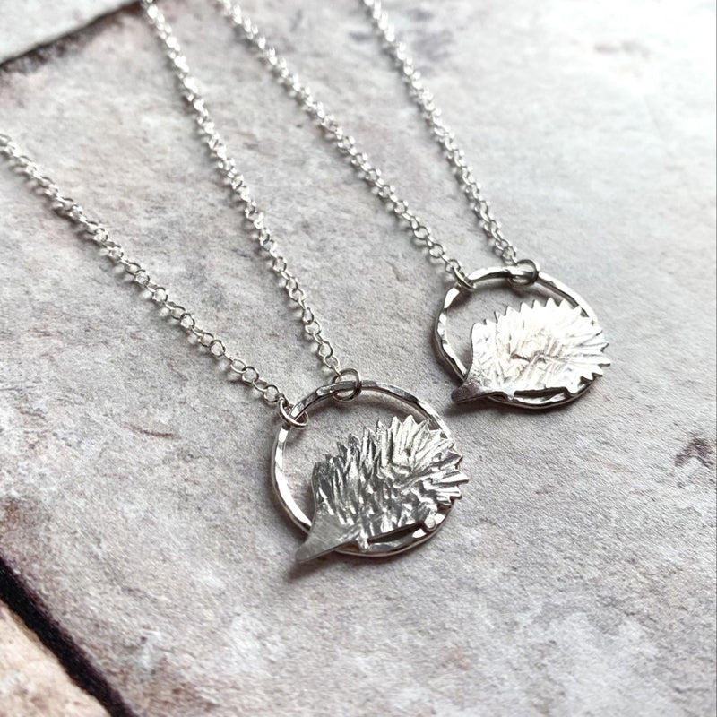To hedgehog necklaces, 2D silver hedgehogs sat on a hammered silver open circle. by zoe ruth designs