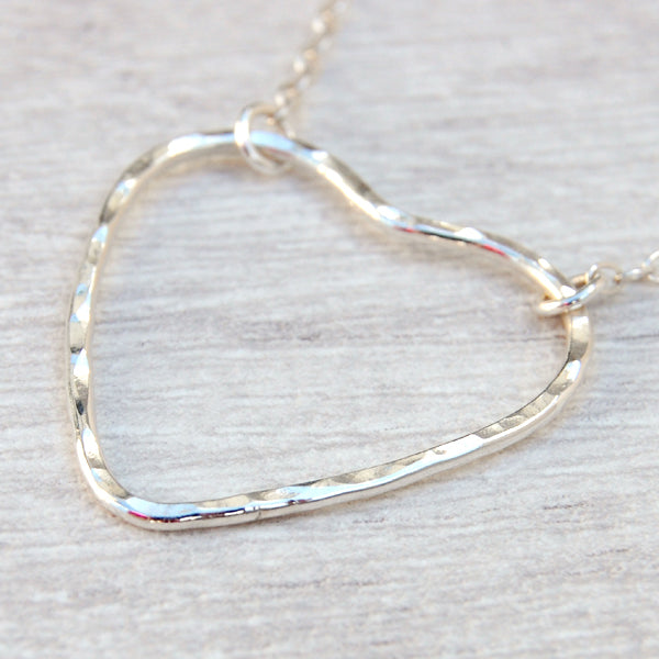 A sterling silver heart outline with a hammered surface sits at the focal point of the necklace, the chain being attacted by jumprings at two moveable places on the heart, by zoe ruth designs