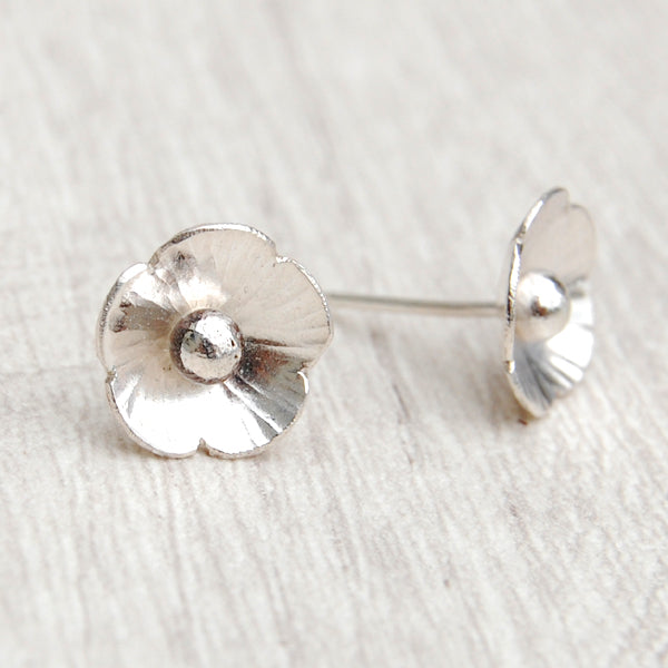 Two sterling silver 5 petal flowers, hammered on the petals and with 3D silver ball centres, one turned to the side to show the earring stud on the back,  by zoe ruth designs