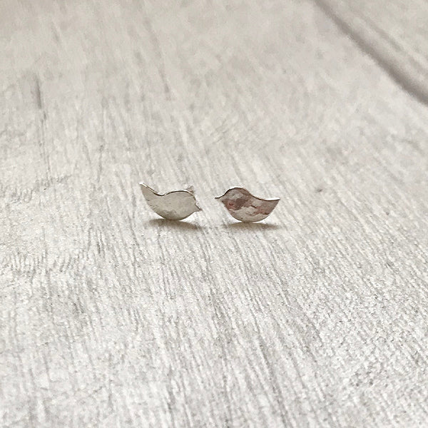 There are two small bird silhouettes in hammered silver to make these two stud earrings, by zoe ruth designs