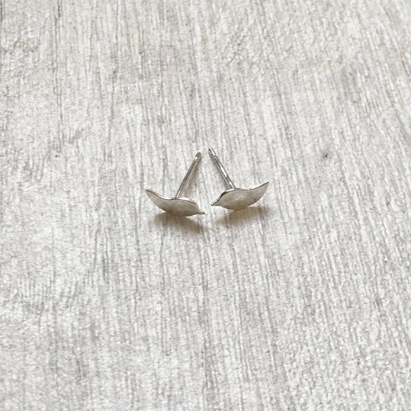 There are two small bird silhouettes in hammered silver to make these two stud earrings, by zoe ruth designs