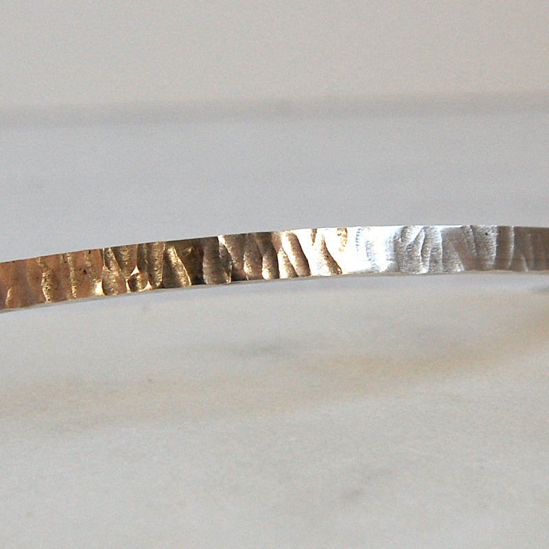 Showing the hammer markings on the surface of the handmade bangle