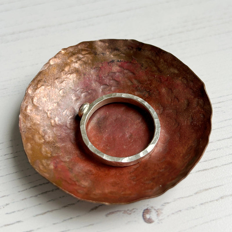 showing the hand textured edge of a handmade silver ring