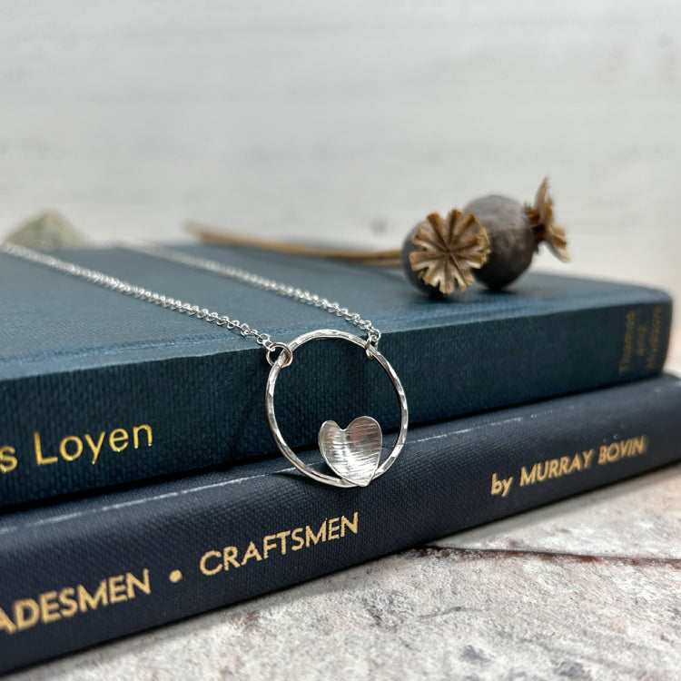 Silver heart on silver circle necklace