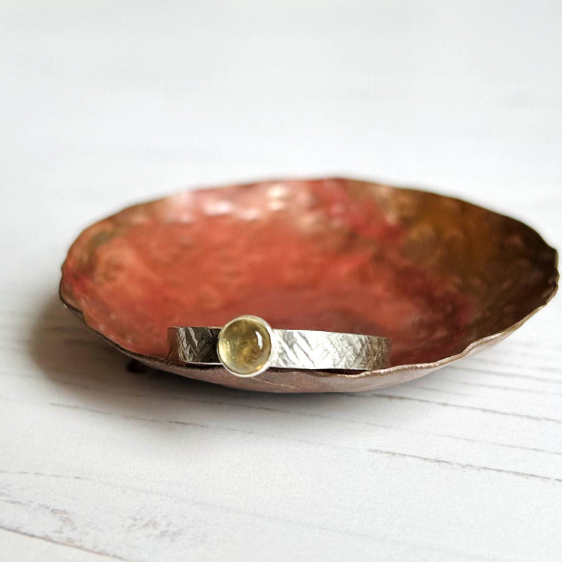 Showing the honey golden citrine stone and the linear texture on the rings silver band