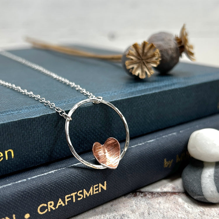 Copper heart on silver circle necklace