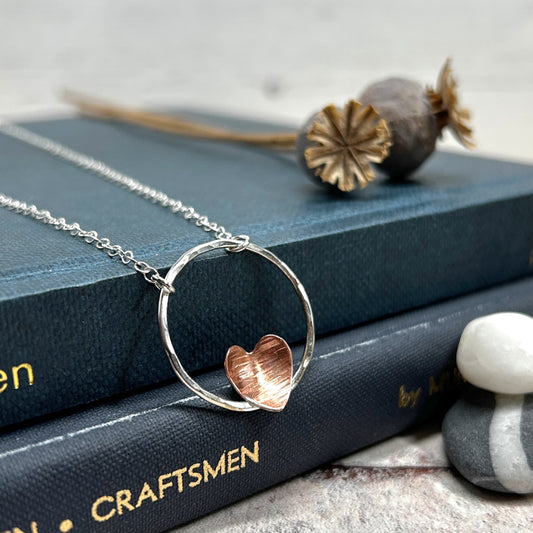 Copper heart on silver circle necklace