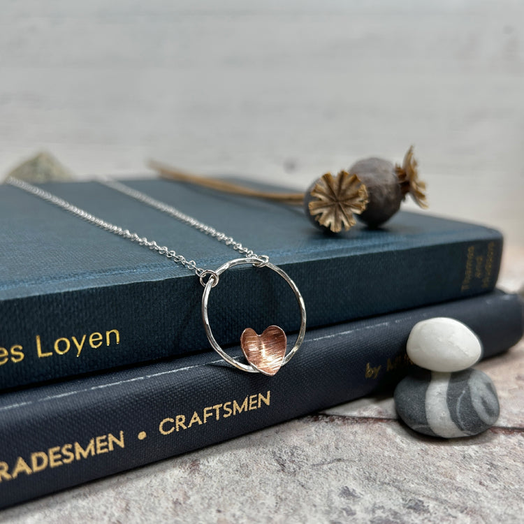 Copper heart on silver circle necklace