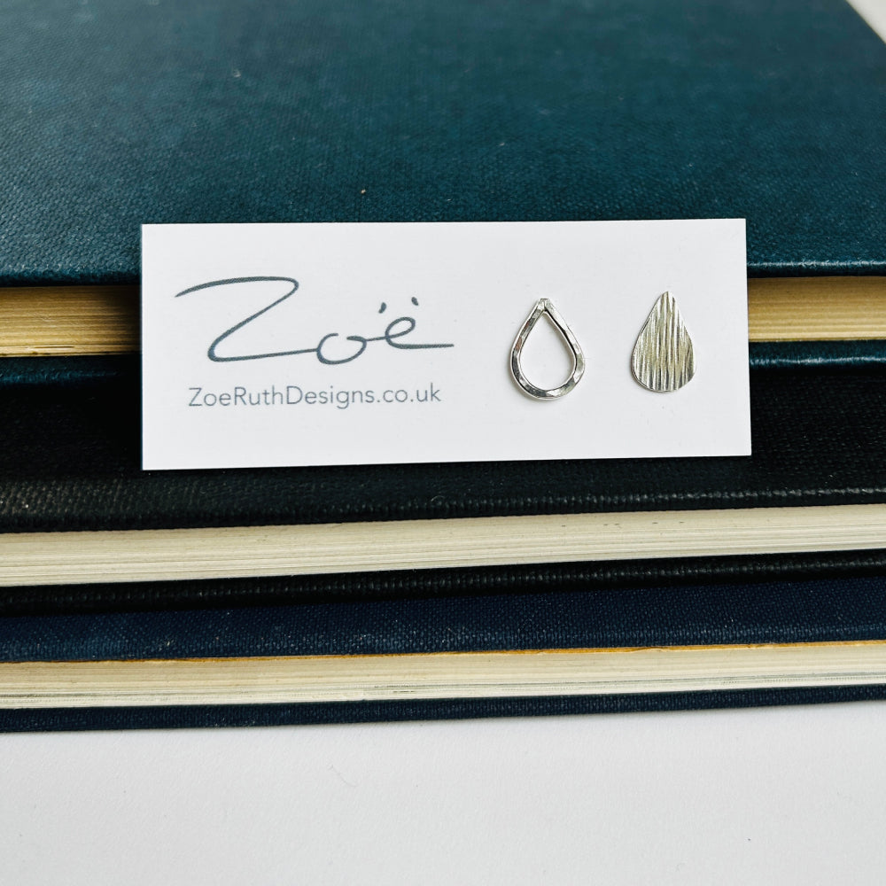 Handmade sterling silver raindrop stud earrings displayed on their logo card packaging of Zoe Ruth Designs