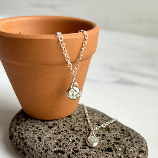 Handmade star stamped silver pebble necklace