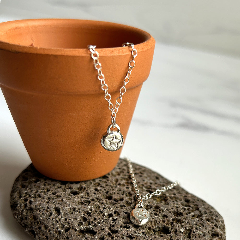 Handmade star stamped silver pebble necklace