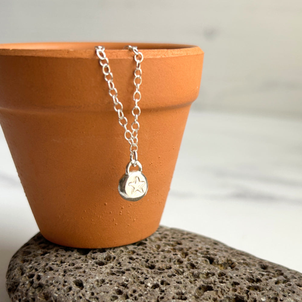 Handmade star stamped silver pebble necklace