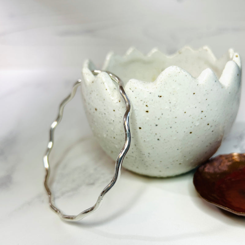 handmade sterling silver bangle showing the wavy shape