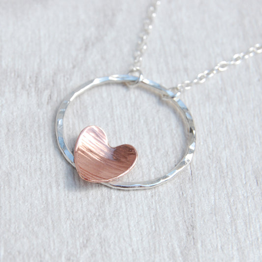 Copper heart on silver circle necklace