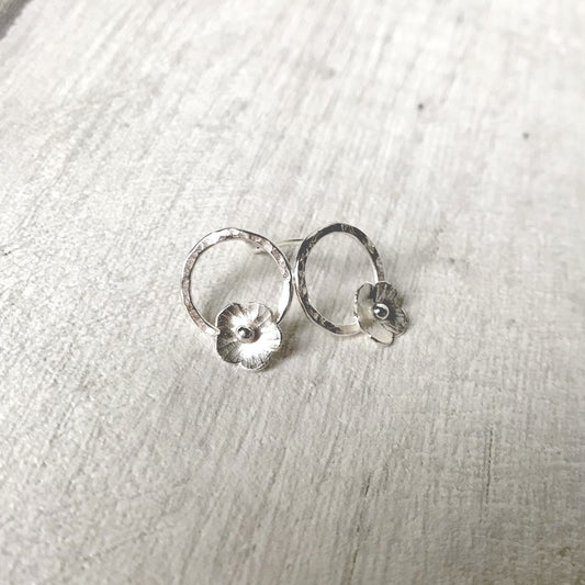 Silver flowers on silver circle studs