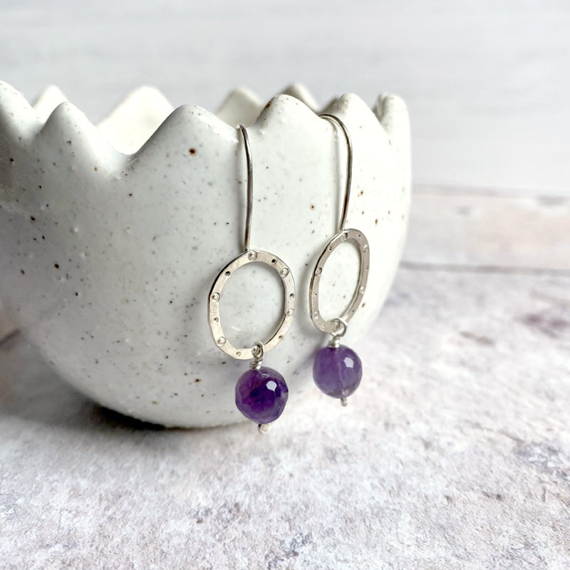 Sterling silver ovals with dots hammered pattern on long hooks with hanging amethyst stone xoe ruth designs