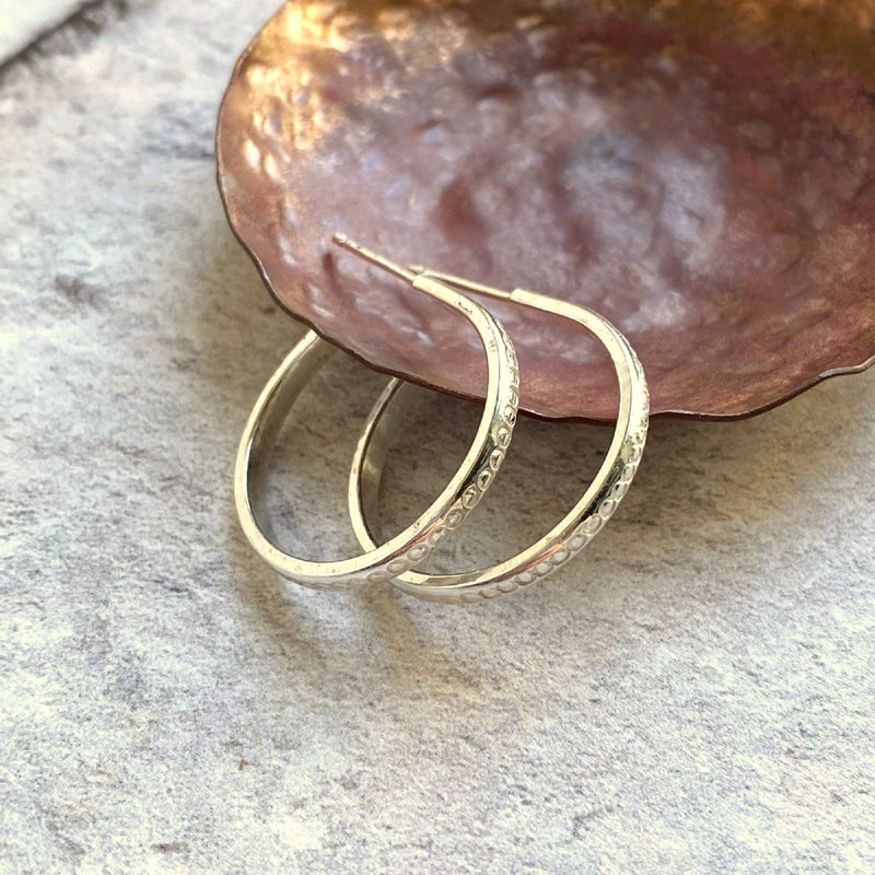 sterling silver hoop earrings with stud fixing circle texture stamped on surface