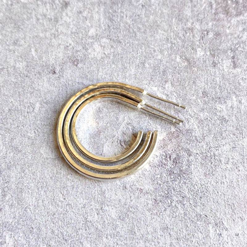 Three silver hoop studs earrings laying inside each other to show the size comparison by zoe ruth designs
